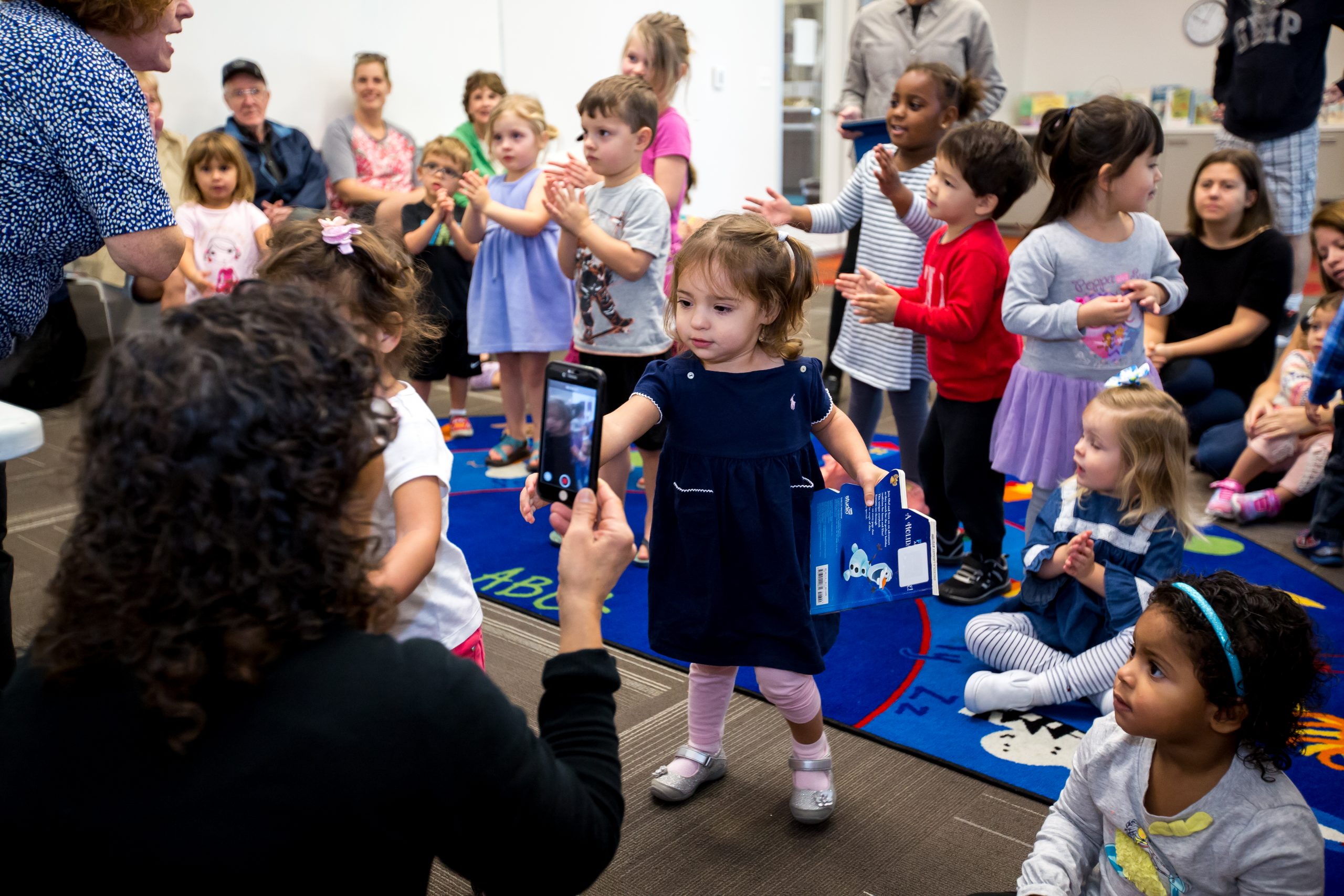 Children gather around a storyteller.